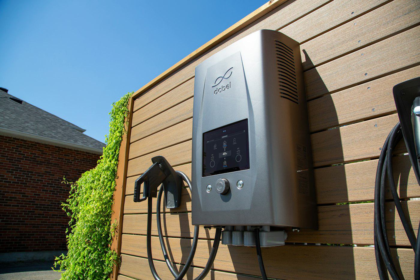 Wall-mounted electric vehicle charger outside a building